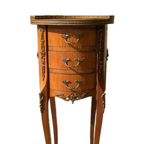 fig 1. An antique circular French kingwood bedside cabinet with three drawers, geometric parquetry inlay, ornate brass mounts, and cabriole legs.