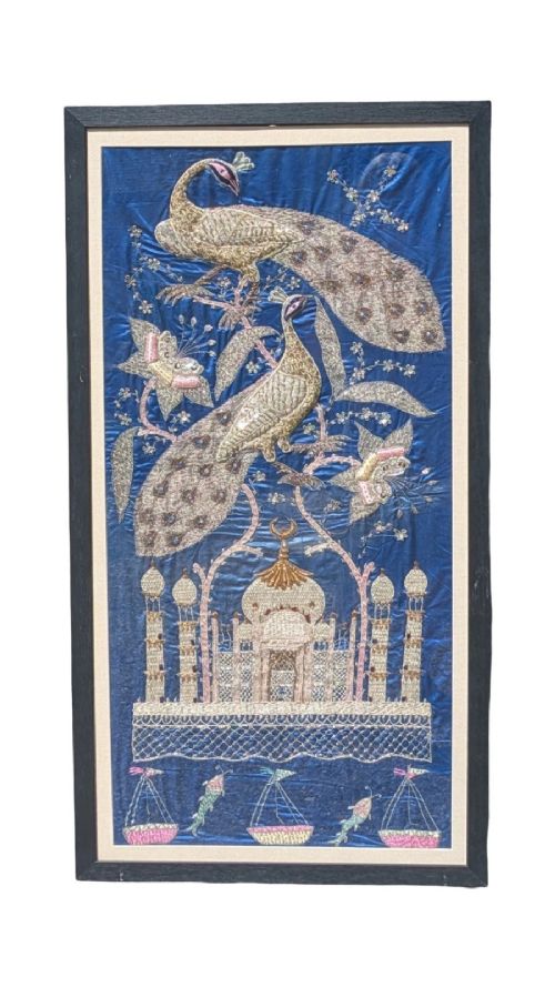 A framed vertical silk textile panel displaying metallic thread zardozi embroidery of peacocks, flowers, and the Taj Mahal on a cobalt blue ground.