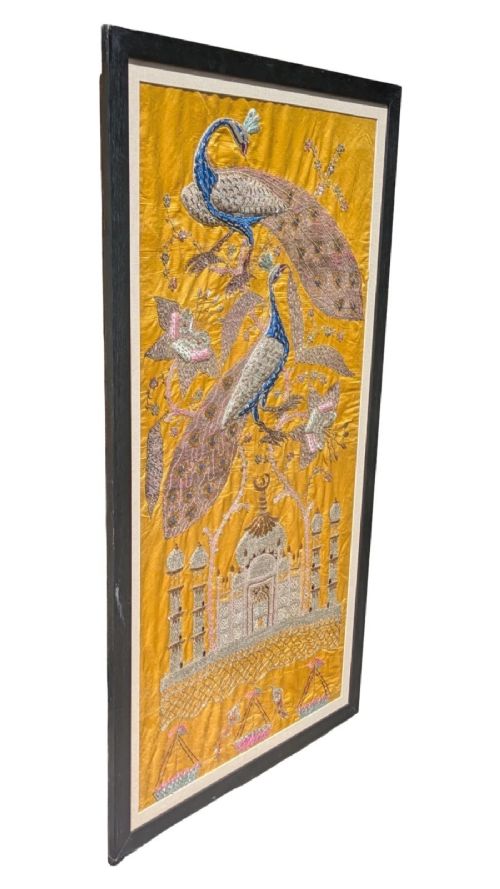 Framed vertical yellow silk panel embroidered with two peacocks, floral motifs, and an architectural depiction of the Taj Mahal in metallic thread. View II