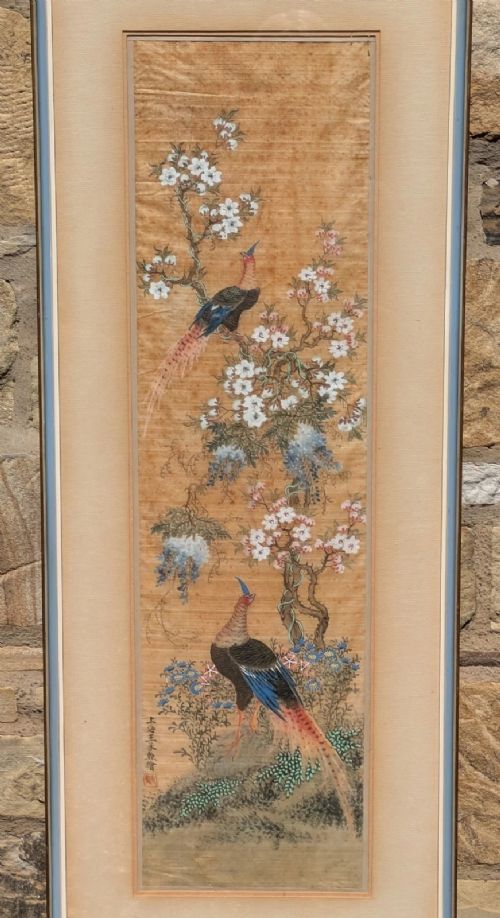 A vertical framed Chinese watercolour on silk depicting two colourful pheasants among blossoming tree branches and floral foliage. View V