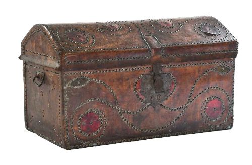fig 1. An 18th-century George II brown leather trunk embellished with decorative brass studding, iron side handles, and an open hinged lid revealing a printed floral paper interior.