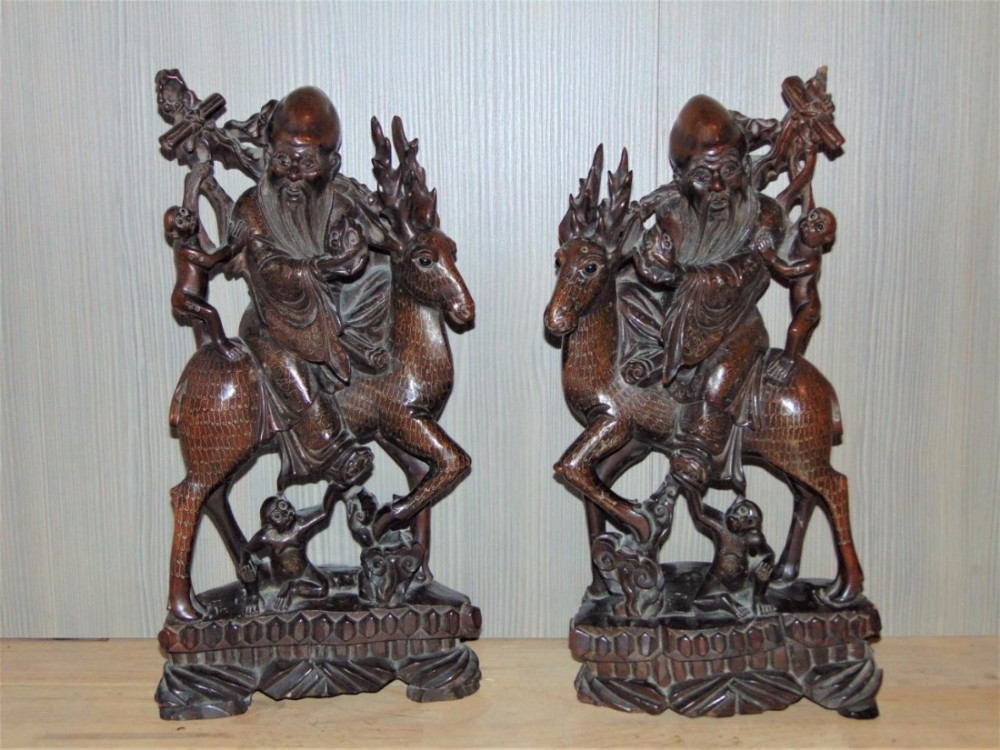 Pair of 19th Century Chinese Silver Inlaid Hardwood Immortals Riding Stags