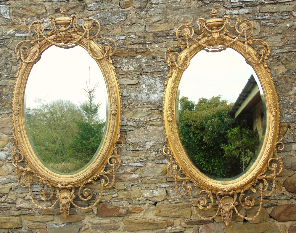 Outstanding Pair of Large Antique Gilt and Gesso Oval Mirrors in the Adam Style