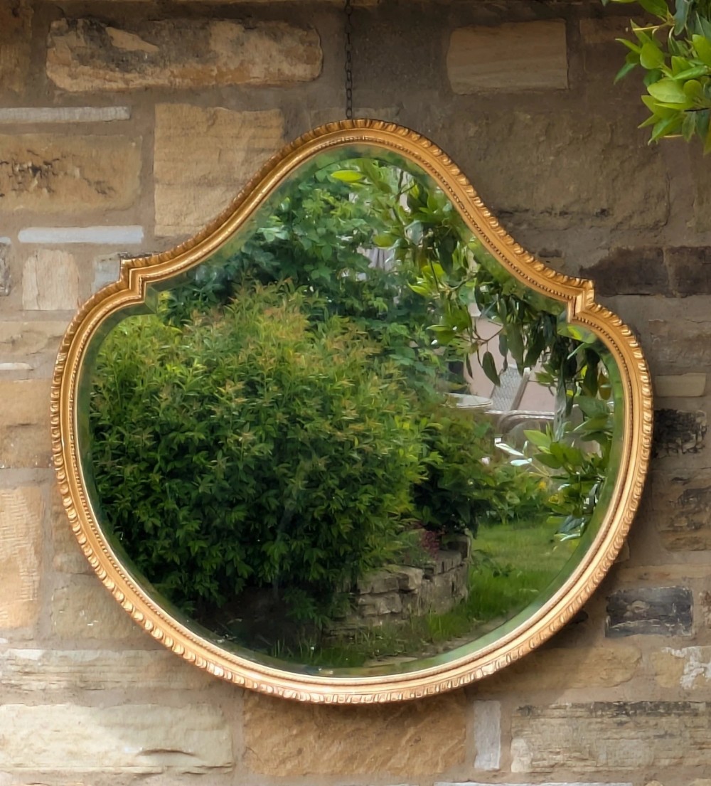 A Gilt and Gesso Cartouche-Shaped Mirror, late 19th century
