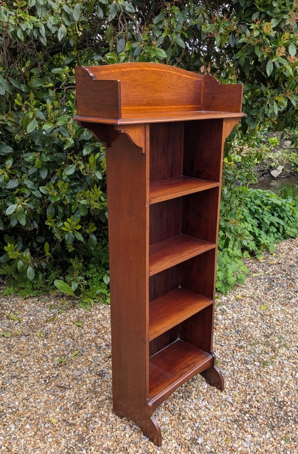 A tall, narrow Edwardian mahogany open bookcase with string inlay, featuring four open shelves and a raised gallery back. View II
