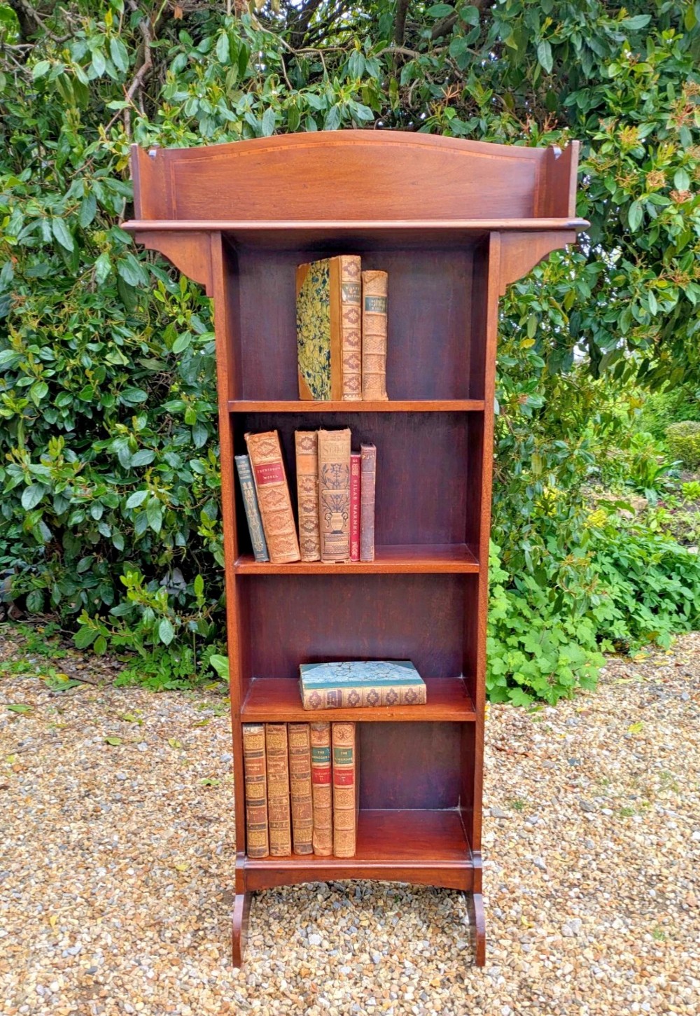 A tall, narrow Edwardian mahogany open bookcase with string inlay, featuring four open shelves and a raised gallery back. View III