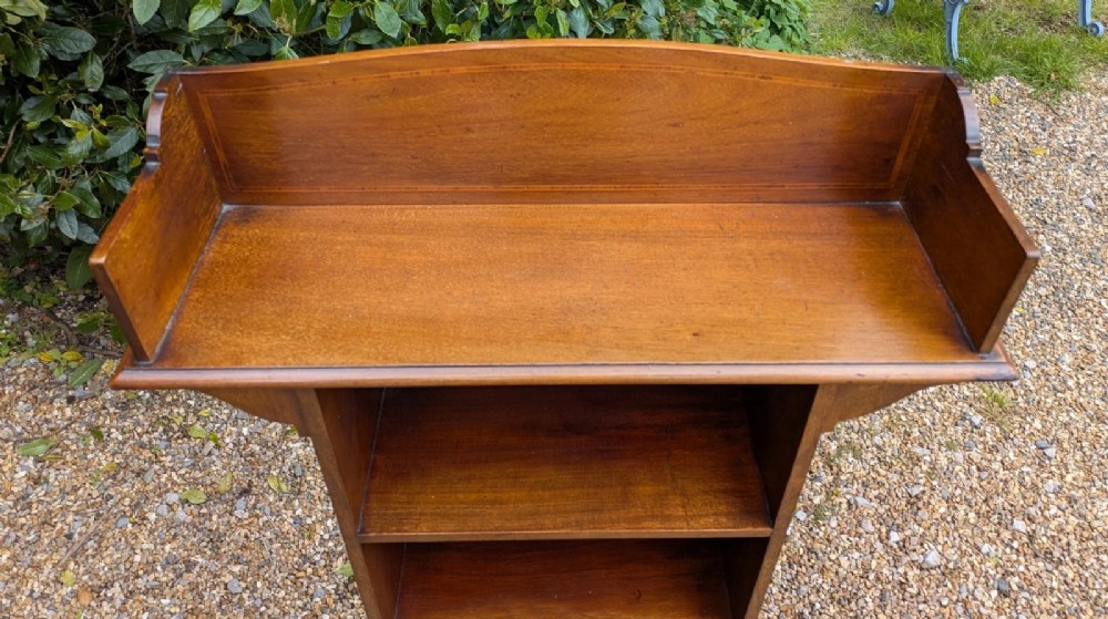 A tall, narrow Edwardian mahogany open bookcase with string inlay, featuring four open shelves and a raised gallery back. View V