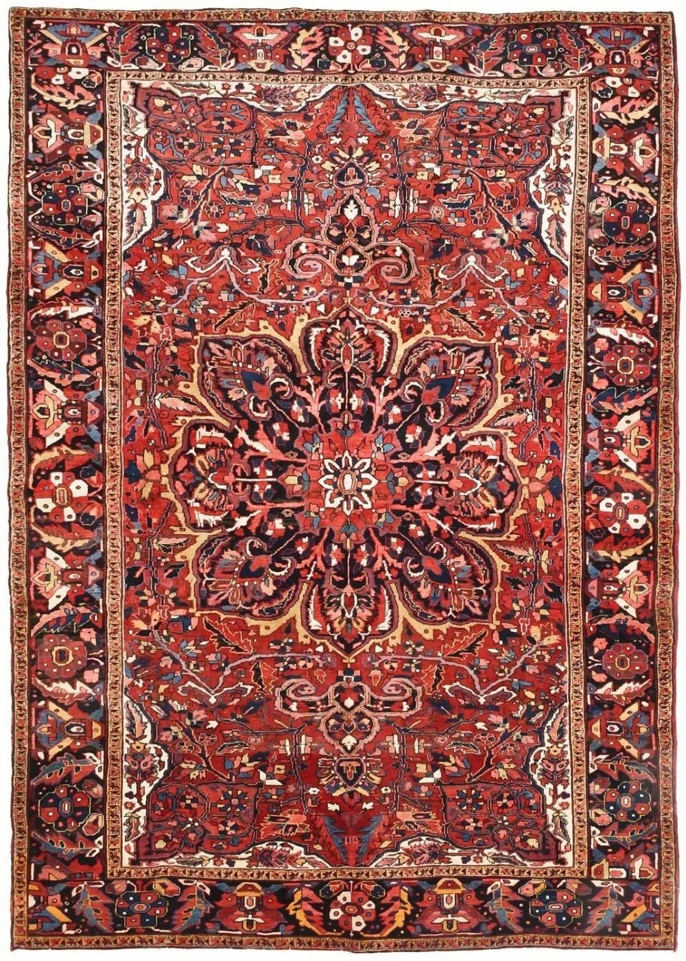 An antique hand-knotted Ahar Heriz wool carpet featuring a large central floral medallion surrounded by detailed vine motifs in rust red, navy blue, and ivory tones.