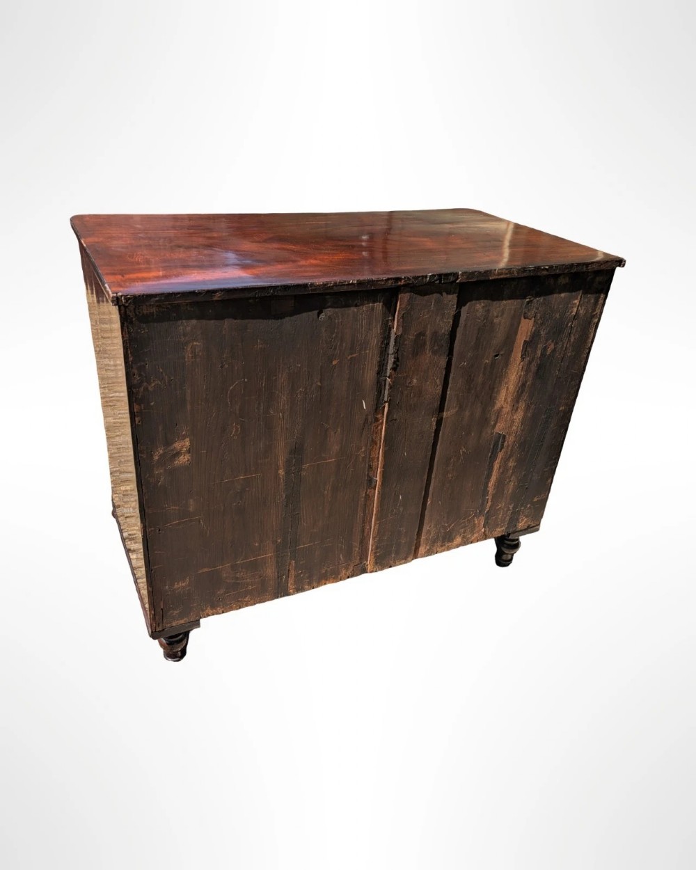 A George III mahogany chest of drawers featuring three full-width drawers with oval brass drop handles, reeded side columns, and turned feet. View IX