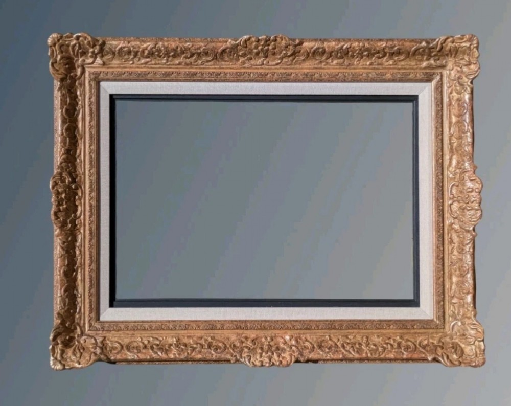 A large rectangular Montparnasse picture frame featuring ornate carved shell and scroll motifs with a cream linen inner slip.