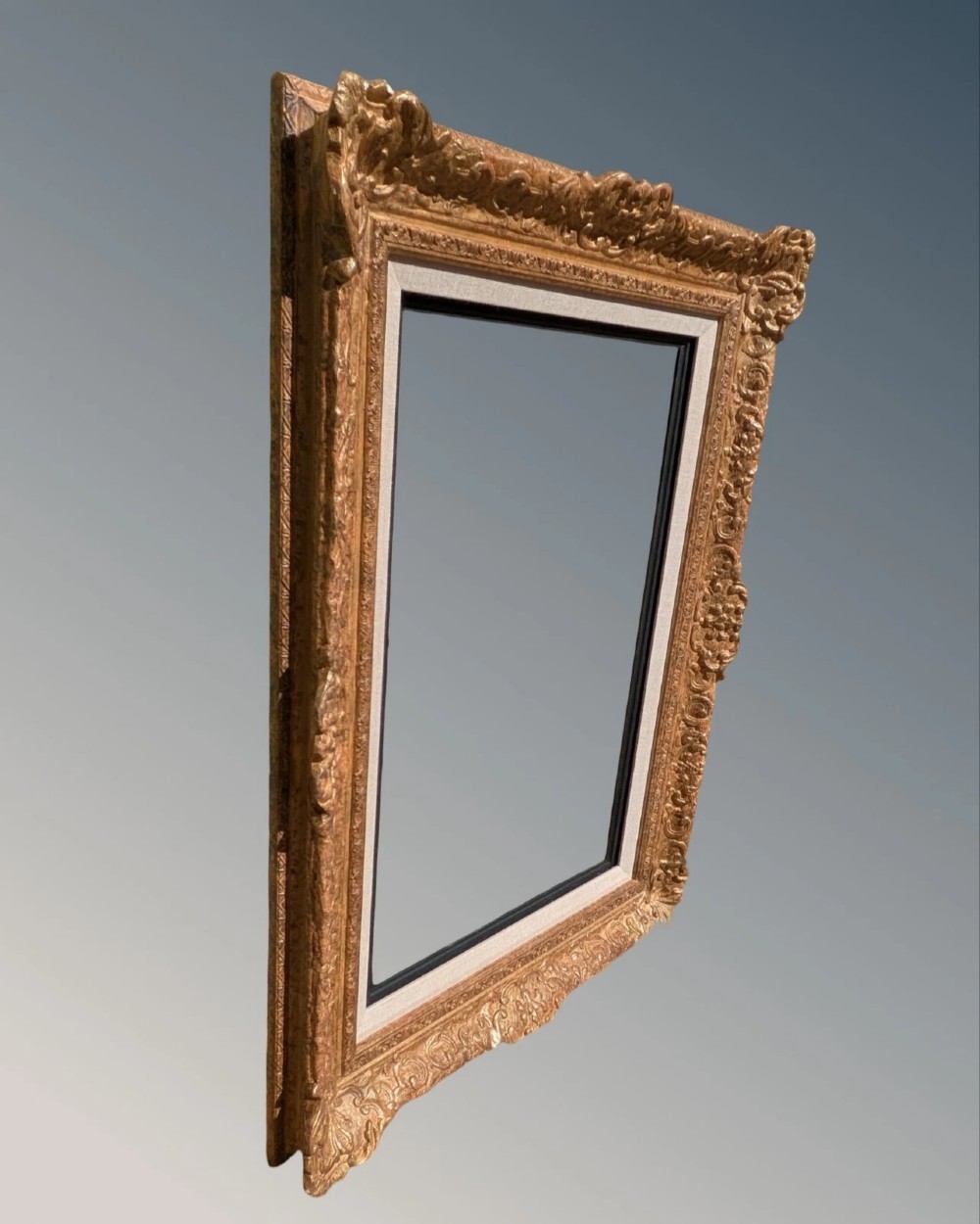 A large rectangular Montparnasse picture frame featuring ornate carved shell and scroll motifs with a cream linen inner slip. View II