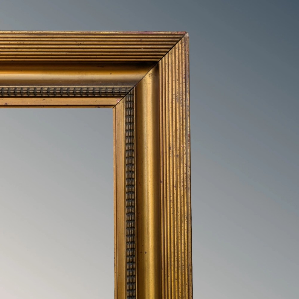 A rectangular antique gilt picture frame featuring a reeded outer border, a deep cove profile, and beaded inner moulding. View III