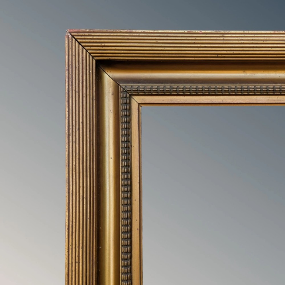 A rectangular antique gilt picture frame featuring a reeded outer border, a deep cove profile, and beaded inner moulding. View IV