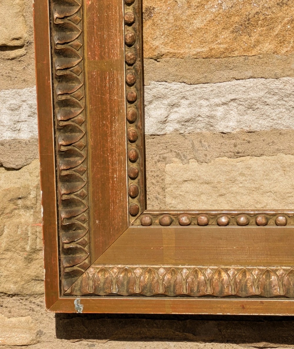 An early twentieth-century rectangular giltwood picture frame featuring classical egg and dart outer moulding and an inner beaded border. View III