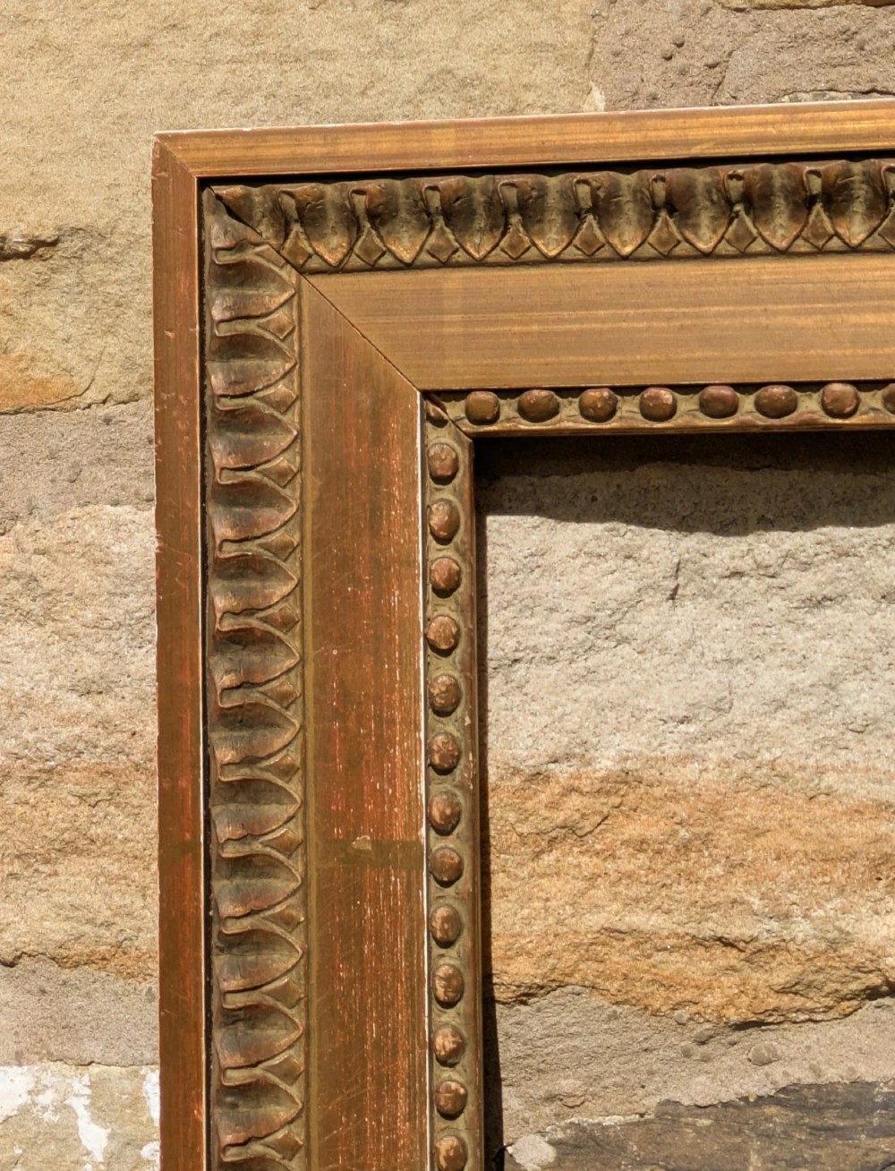 An early twentieth-century rectangular giltwood picture frame featuring classical egg and dart outer moulding and an inner beaded border. View IV