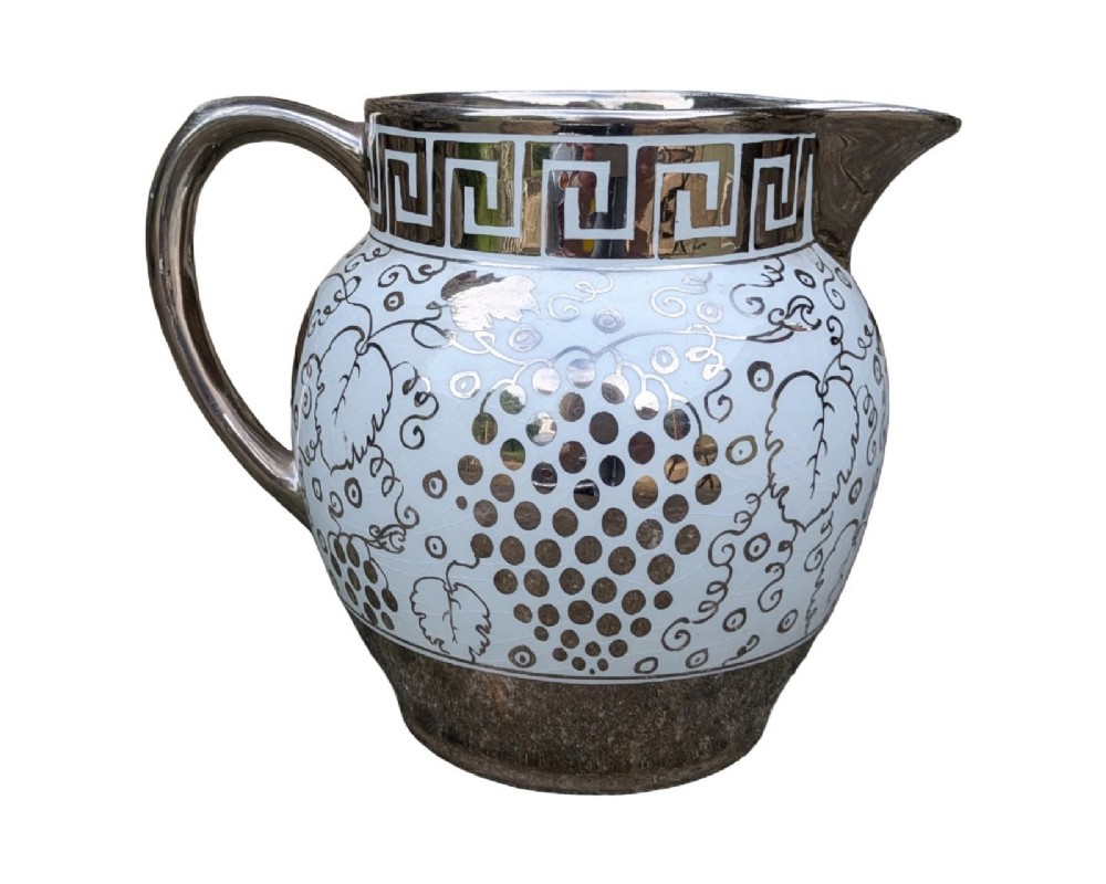 A white pearlware ceramic jug with silver lustre trim, featuring a Greek key band along the neck and a grape and vine pattern around the body. View III