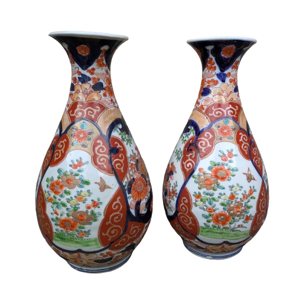A pair of pear-shaped Japanese Imari porcelain vases decorated with cobalt blue, iron-red, and gold floral panels. View II