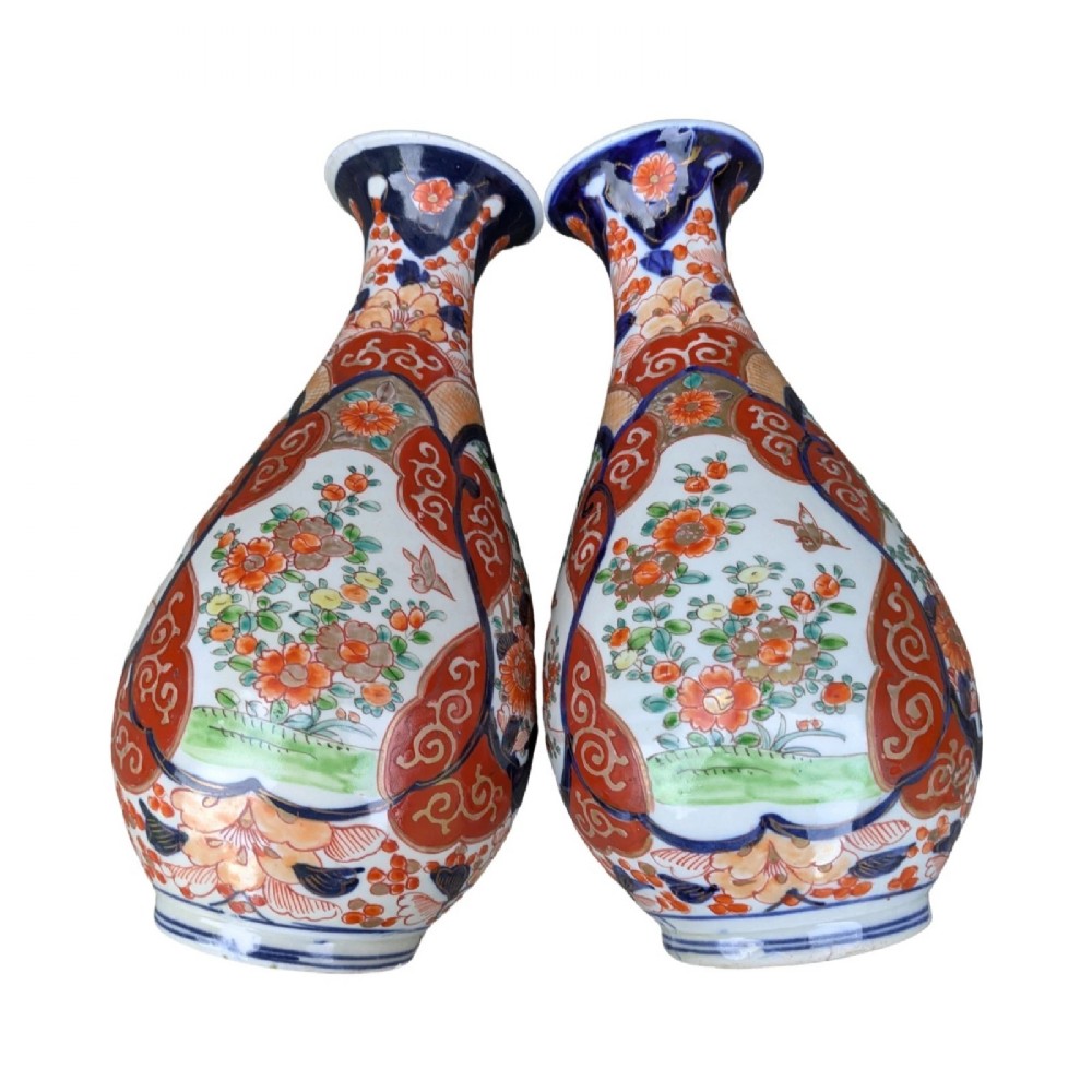 A pair of pear-shaped Japanese Imari porcelain vases decorated with cobalt blue, iron-red, and gold floral panels. View V
