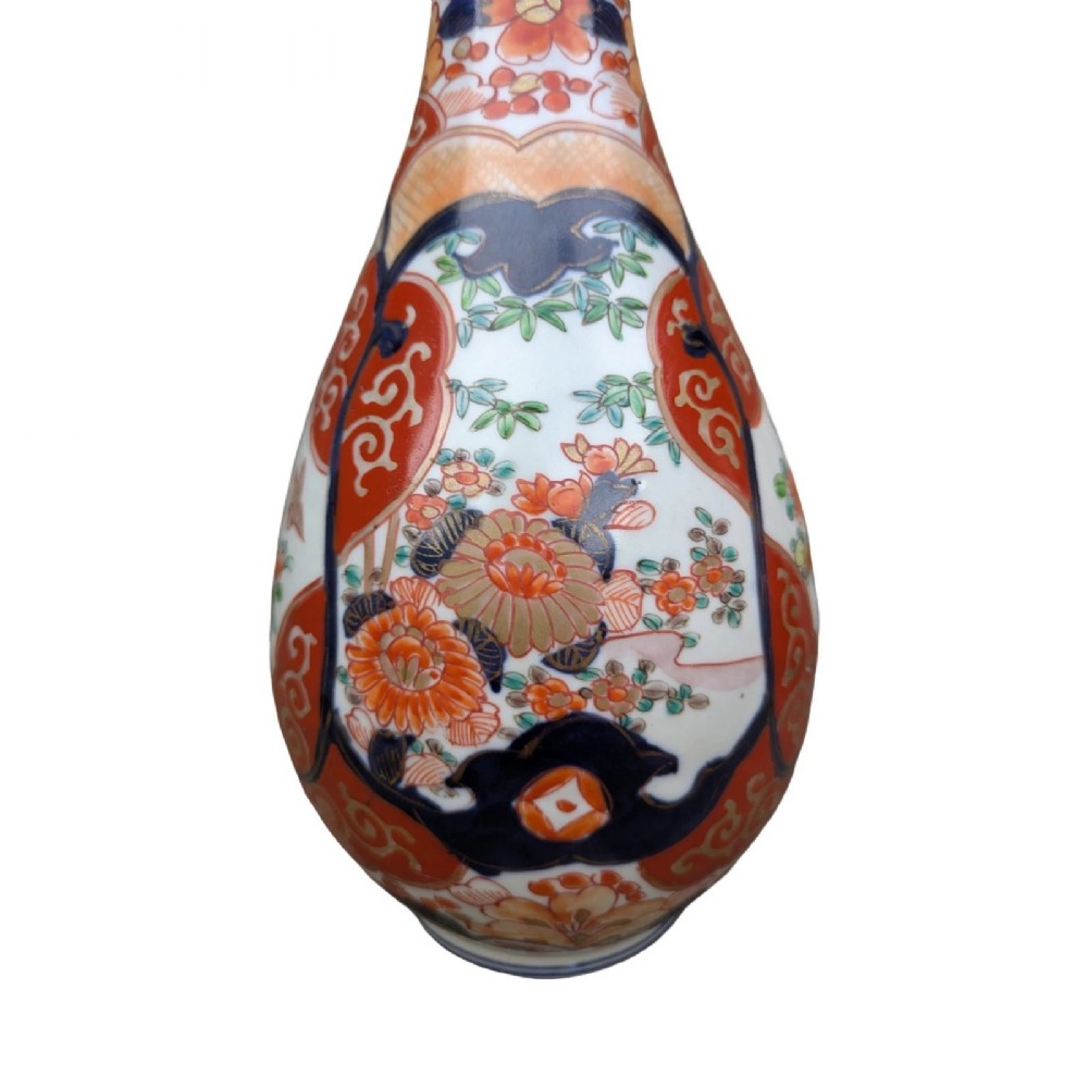 A pair of pear-shaped Japanese Imari porcelain vases decorated with cobalt blue, iron-red, and gold floral panels. View VI