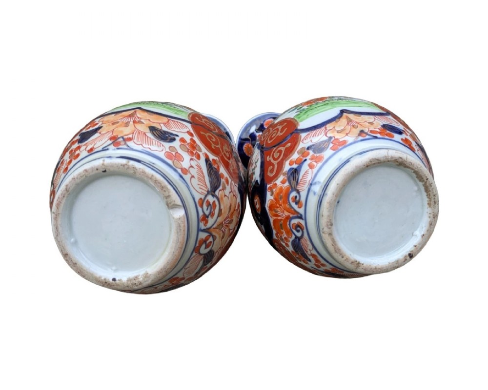 A pair of pear-shaped Japanese Imari porcelain vases decorated with cobalt blue, iron-red, and gold floral panels. View VIII
