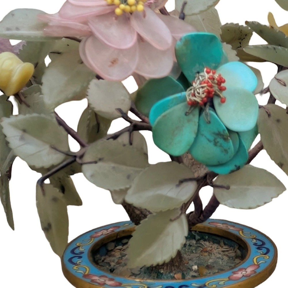 A Chinese ornamental bonsai tree featuring carved hardstone leaves and petals set inside a turquoise floral cloisonne planter. View IV