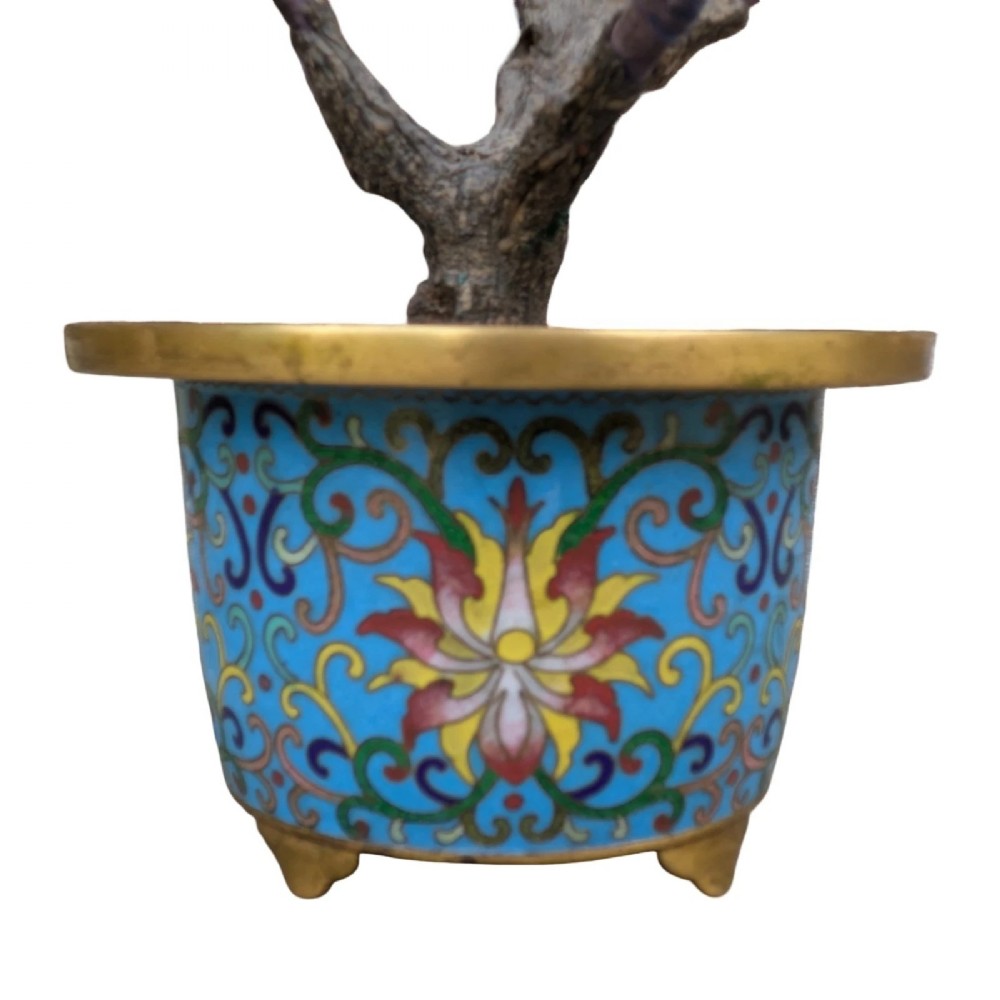 A Chinese ornamental bonsai tree featuring carved hardstone leaves and petals set inside a turquoise floral cloisonne planter. View VI