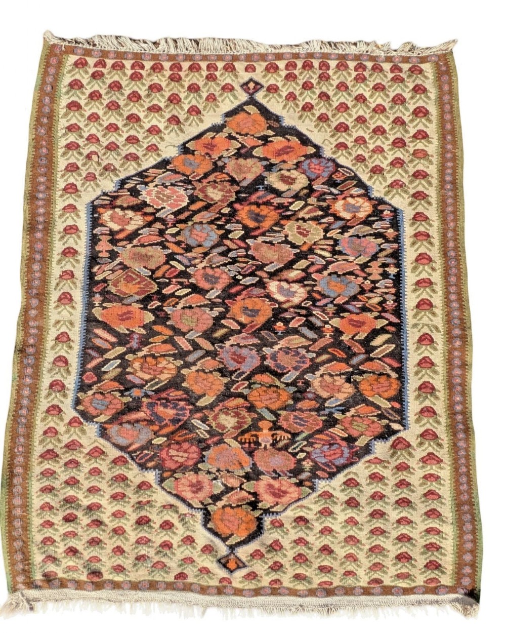 A handwoven flatweave Bidjar kilim rug featuring a dark central diamond medallion surrounded by a light floral pattern and bordered by fringed ends.