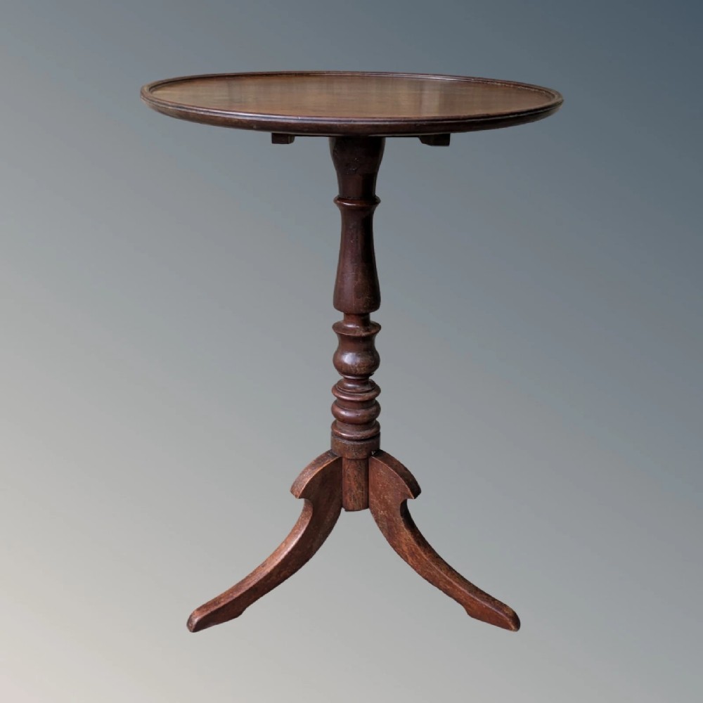 A Georgian mahogany circular tilt-top table featuring a turned central pedestal column resting on a tripod base. View II
