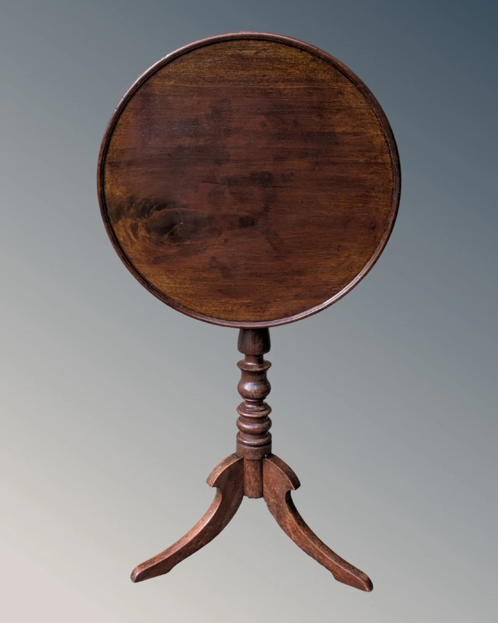 A Georgian mahogany circular tilt-top table featuring a turned central pedestal column resting on a tripod base. View III