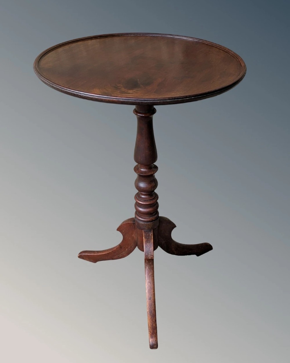A Georgian mahogany circular tilt-top table featuring a turned central pedestal column resting on a tripod base. View IV