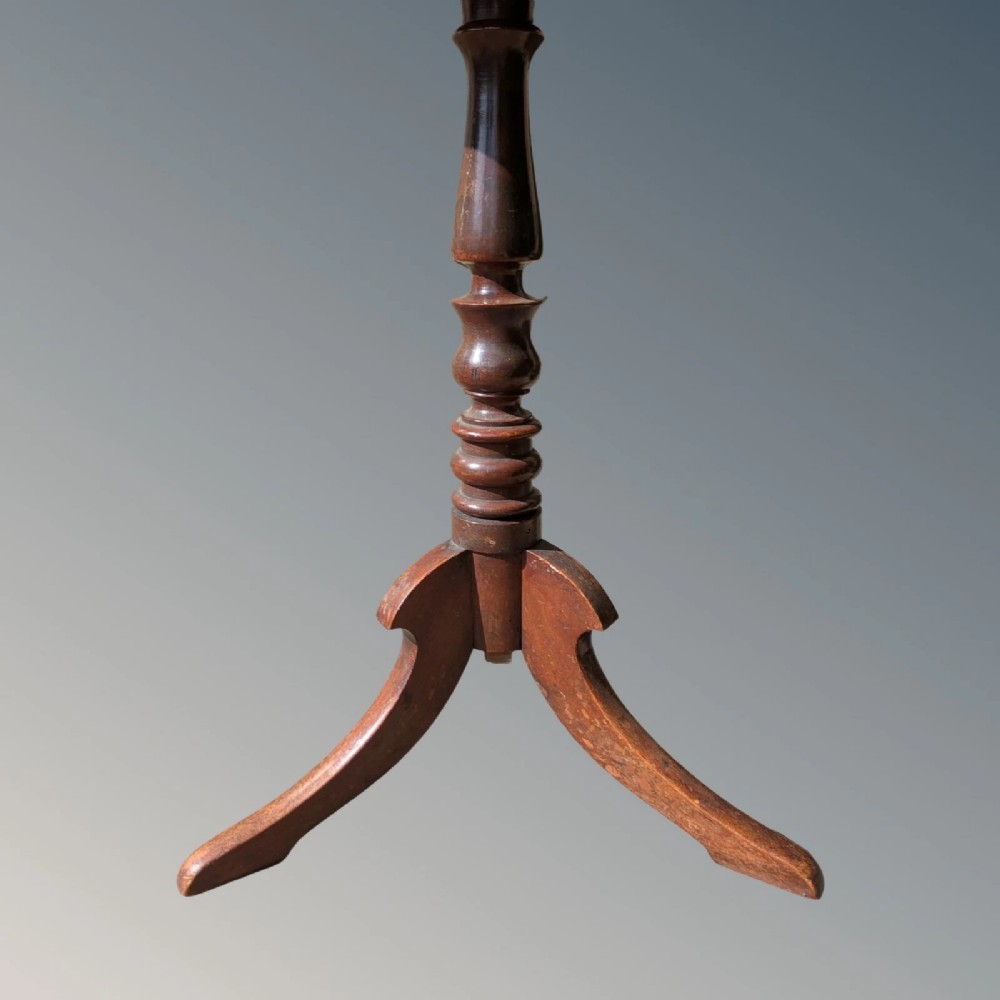A Georgian mahogany circular tilt-top table featuring a turned central pedestal column resting on a tripod base. View VI