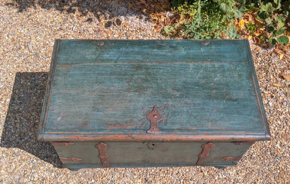 A rectangular teal blue painted pine storage chest featuring hand-forged iron strapwork, corner brackets, and turned bun feet. View VI