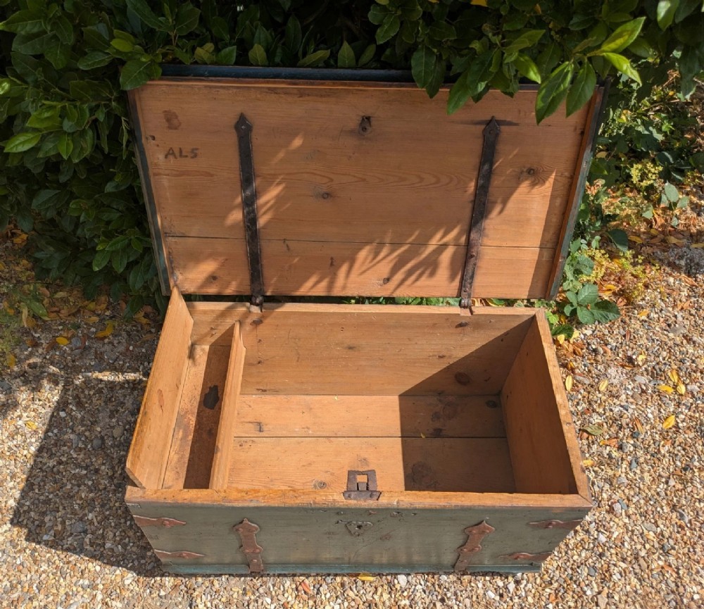 A rectangular teal blue painted pine storage chest featuring hand-forged iron strapwork, corner brackets, and turned bun feet. View VII
