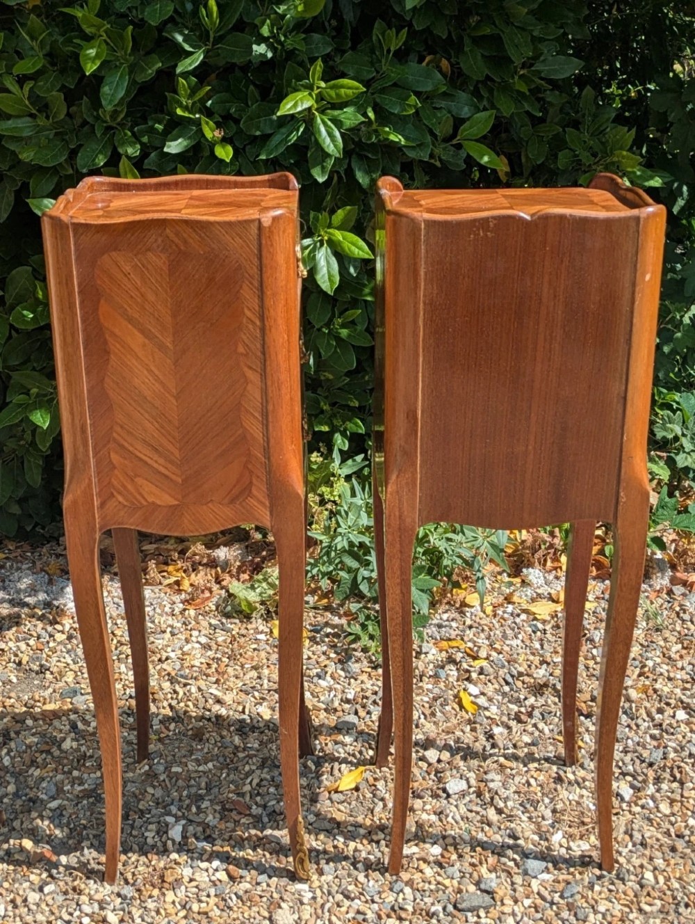 A pair of tall, slim French Louis XV style bedside cabinets crafted with geometric wood parquetry, featuring three drawers with ornate gilt handles and long cabriole legs with metal sabots. View IX