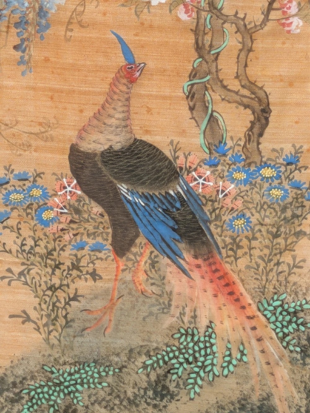A vertical framed Chinese watercolour on silk depicting two colourful pheasants among blossoming tree branches and floral foliage. View VIII
