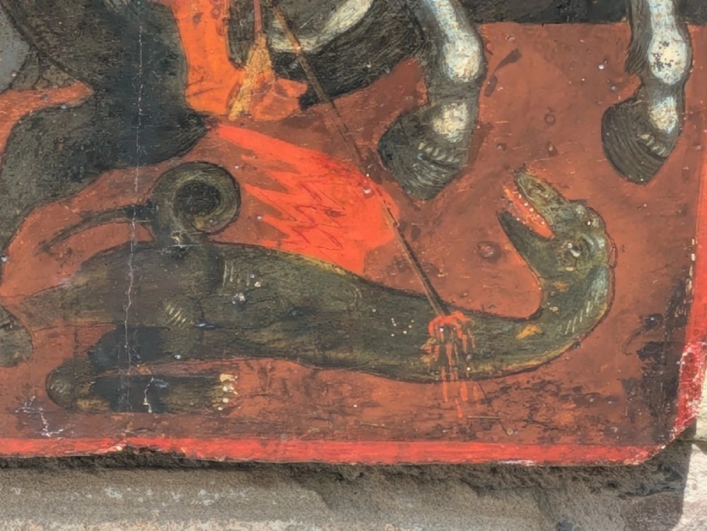 An 18th-century painted wooden icon depicting Saint George on horseback slaying a dragon against a gilded gold leaf background. View VII