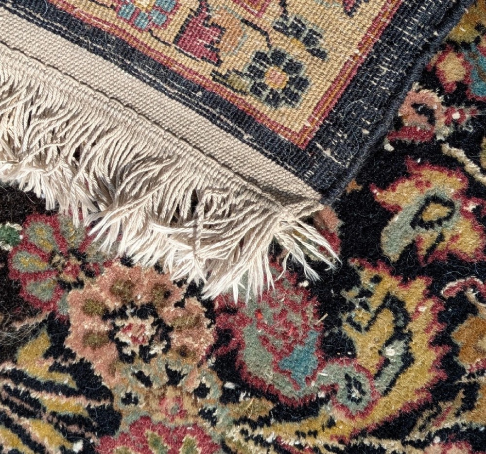 A hand-knotted Isfahan carpet featuring a detailed central medallion surrounded by floral scrollwork and cartouche borders in shades of rose, dark navy, cream, and turquoise. View VII