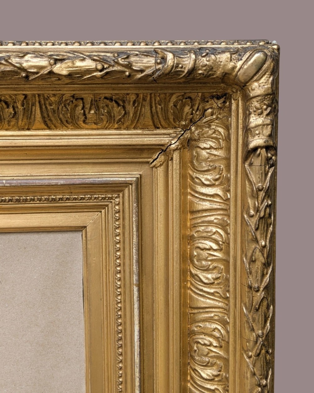 A matching pair of deep profile Victorian gilt picture frames featuring layered cove moulding and carved leaf border details. View V