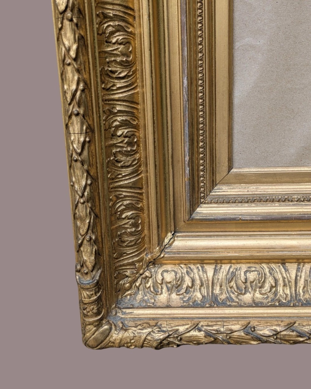 A matching pair of deep profile Victorian gilt picture frames featuring layered cove moulding and carved leaf border details. View VI