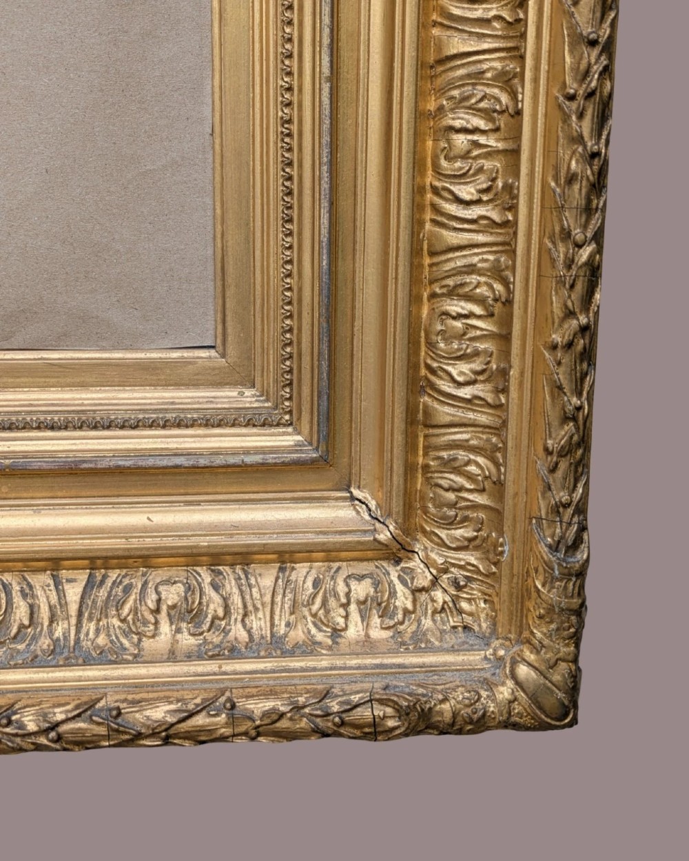 A matching pair of deep profile Victorian gilt picture frames featuring layered cove moulding and carved leaf border details. View VIII