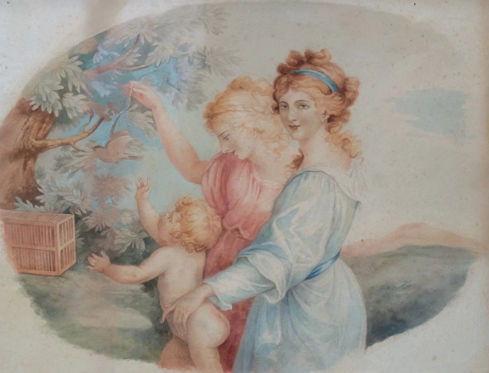A framed classical watercolour painting depicting two draped female figures and a child beneath trees, presented in a moulded gilt frame. View II