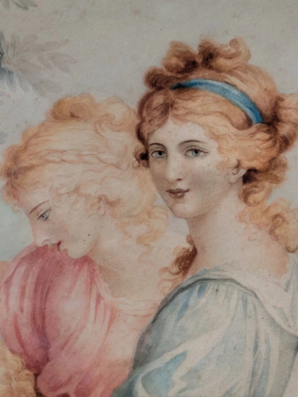 A framed classical watercolour painting depicting two draped female figures and a child beneath trees, presented in a moulded gilt frame. View III