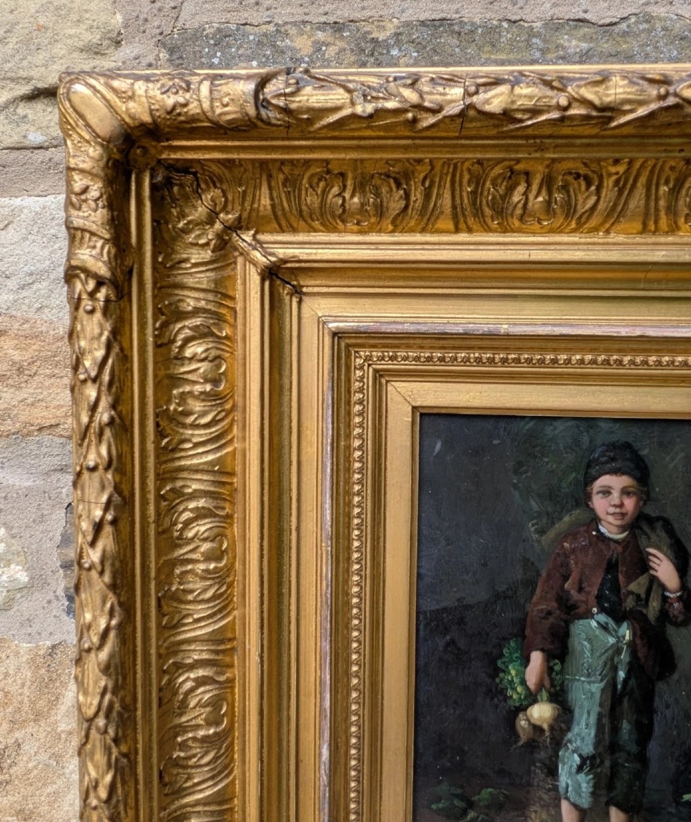 A pair of 19th-century oil paintings depicting young boys in rustic attire, mounted within deep, ornate gilded wooden frames. View VIII
