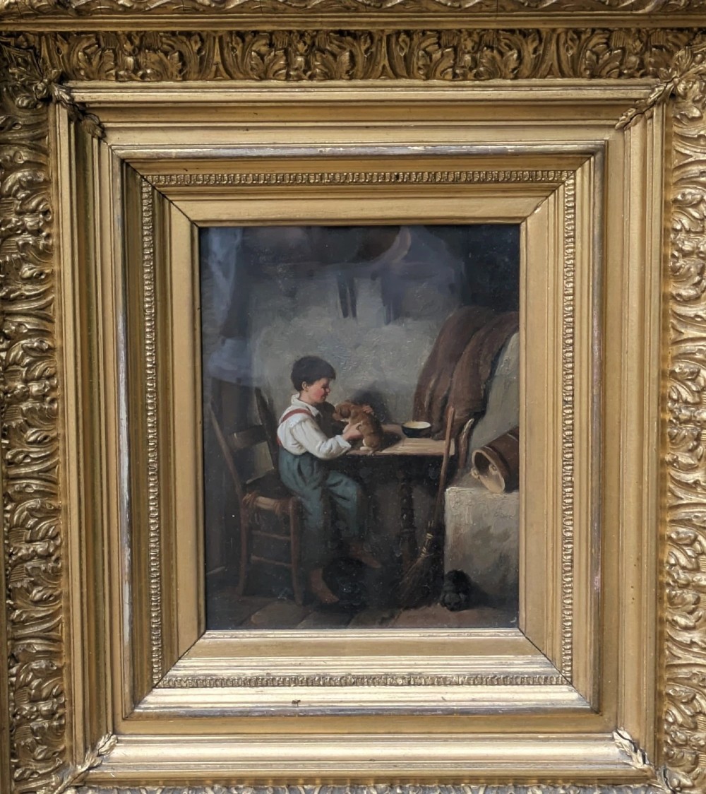 A pair of 19th-century oil paintings depicting young boys in rustic attire, mounted within deep, ornate gilded wooden frames. View IX