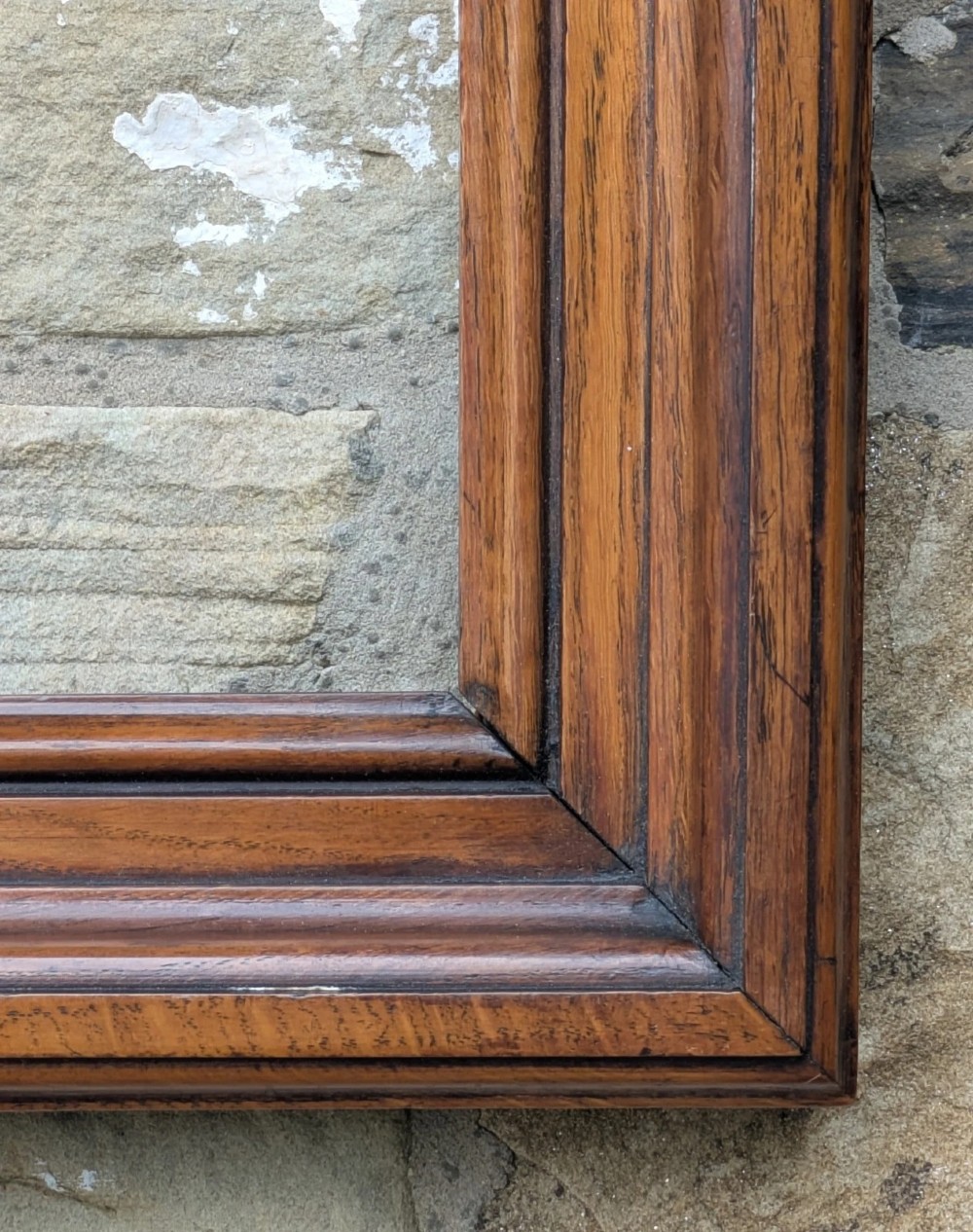 A rectangular antique solid walnut picture frame featuring multi-tiered moulding and mitred corners. View IV