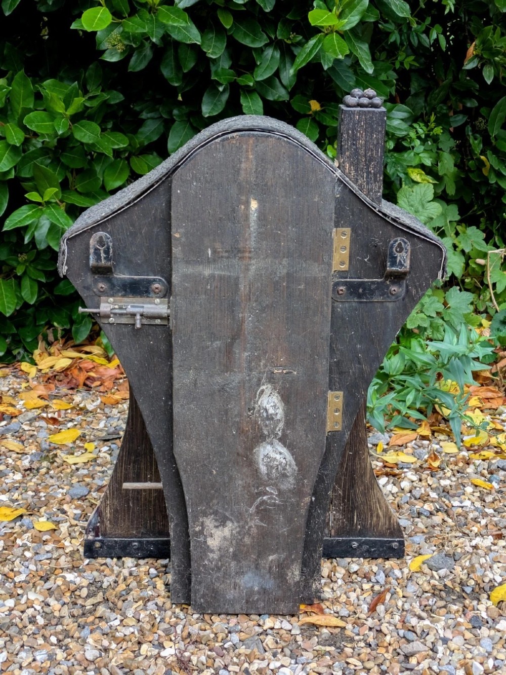 A carved and painted wooden Swedish birdhouse featuring a floral motif in a pot with a central entry hole and a chimney detail. View VI