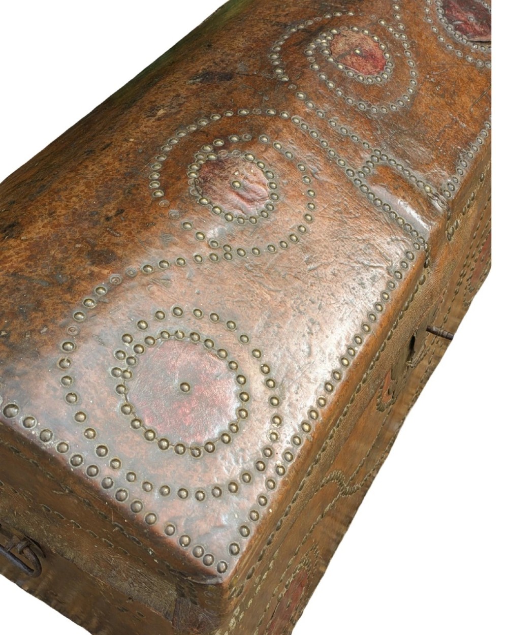 An 18th-century George II brown leather trunk embellished with decorative brass studding, iron side handles, and an open hinged lid revealing a printed floral paper interior. View III
