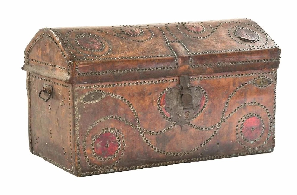 An 18th-century George II brown leather trunk embellished with decorative brass studding, iron side handles, and an open hinged lid revealing a printed floral paper interior. View VIII