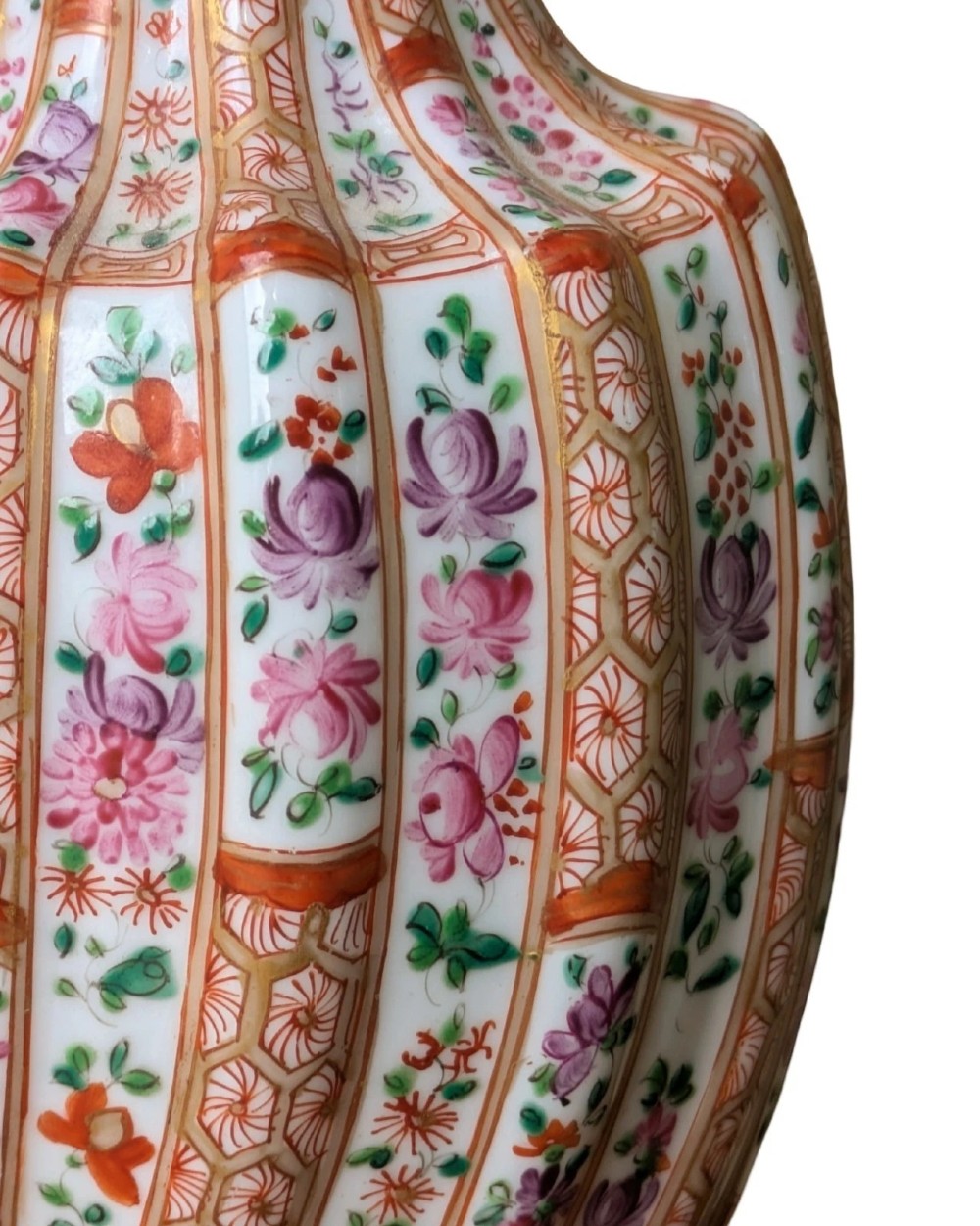 A pair of hand-painted porcelain lidded vases featuring fluted bodies, intricate floral motifs, geometric orange bands, and gilded details on square pedestals. View V