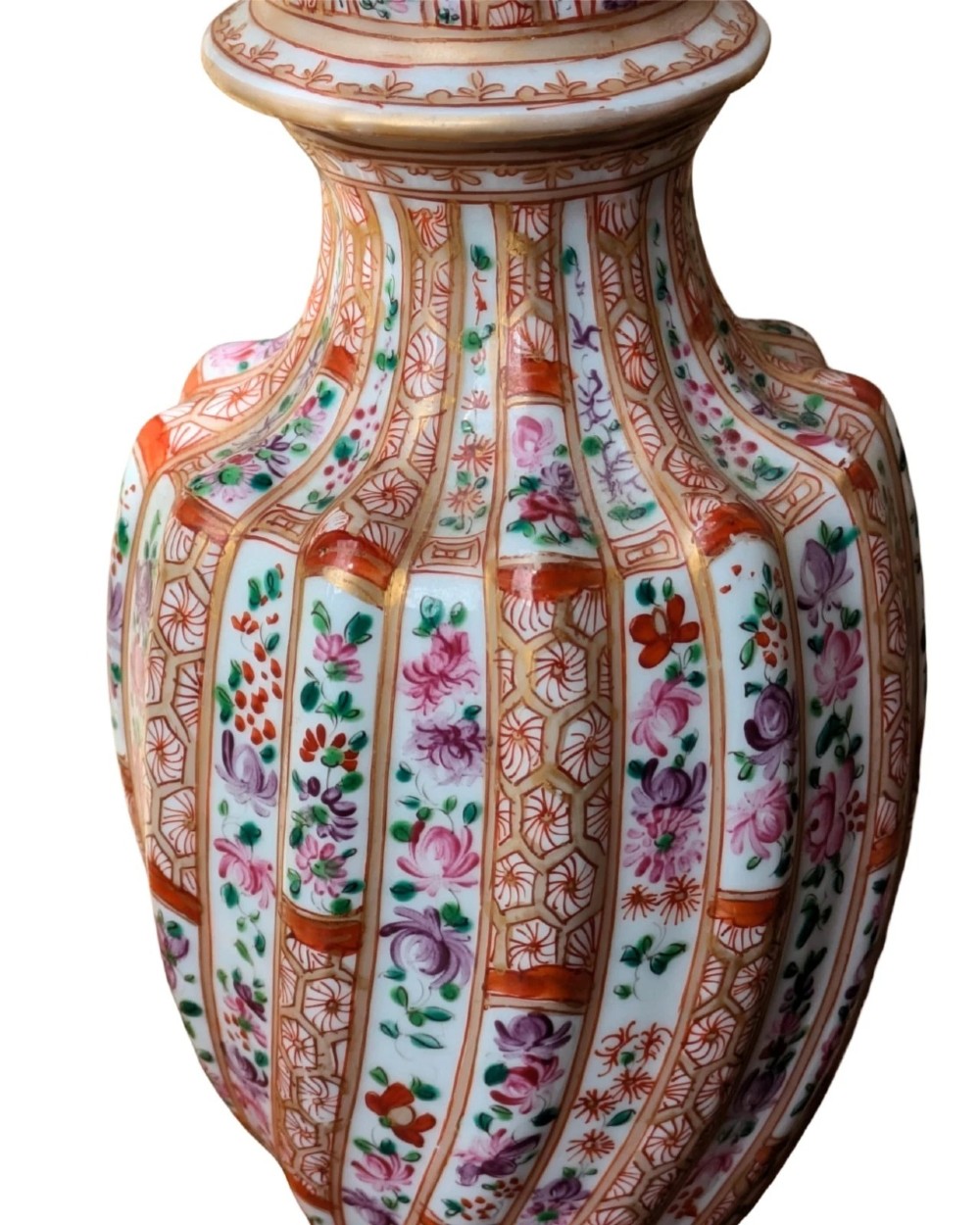 A pair of hand-painted porcelain lidded vases featuring fluted bodies, intricate floral motifs, geometric orange bands, and gilded details on square pedestals. View VI